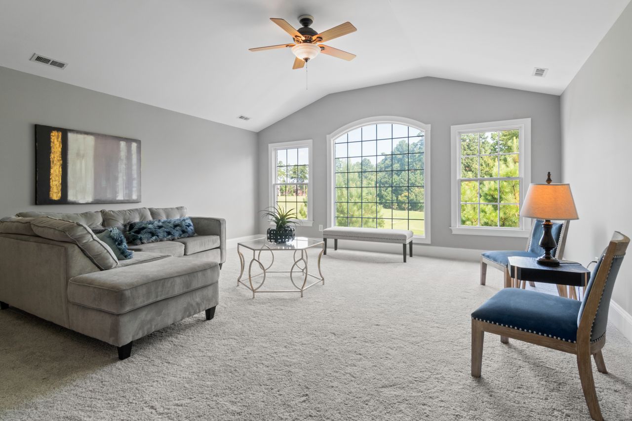get-in-touch Contemporary living room with neutral tones, large windows, and modern furniture.