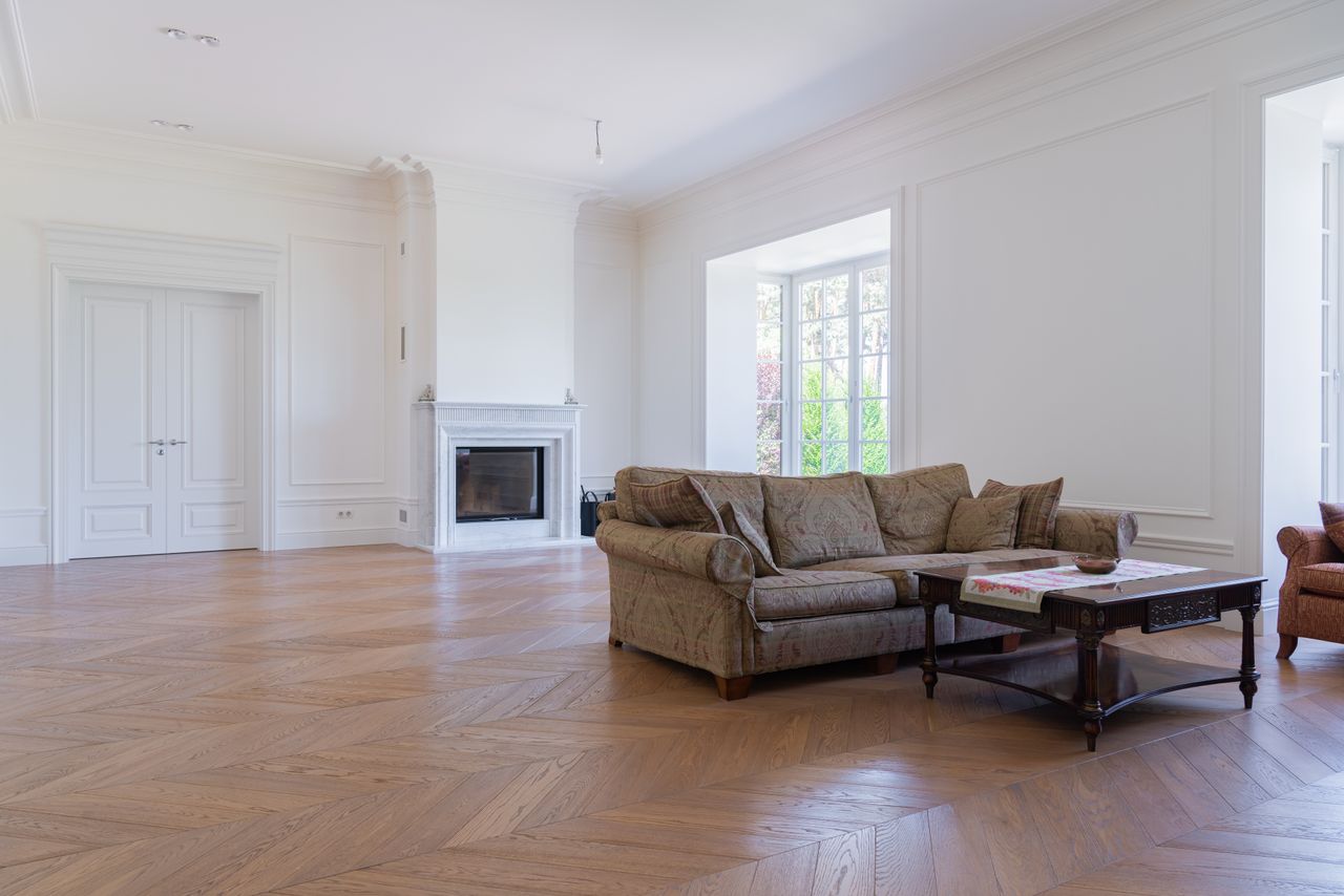 services-06 Beautiful spacious living room featuring elegant modern furniture and hardwood floors.