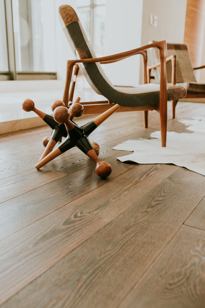 home-hero Stylish modern interior featuring a wooden armchair and unique decorative objects.